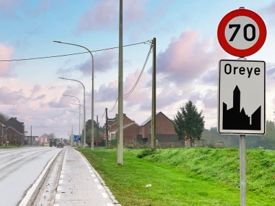 Begin van een bebouwde kom waar maximaal 70 km/u gereden mag worden, tot en met het volgende kruispunt.